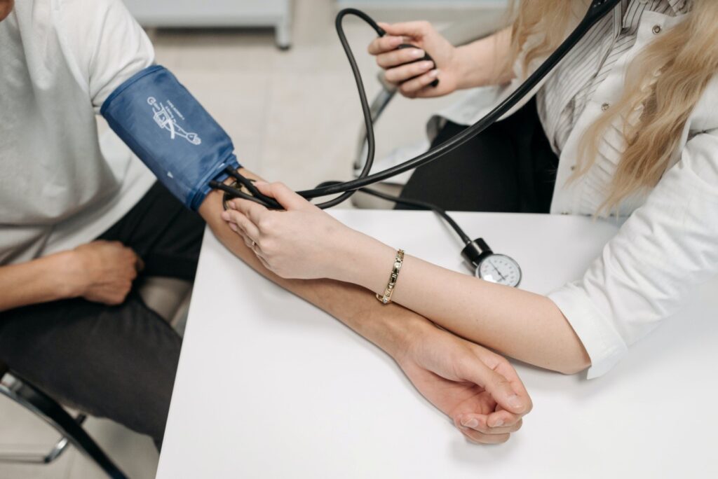 Doctor Taking Blood Pressure Of A Hypertension Patient